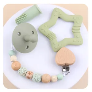 Baby teether set with star-shaped wood ring, pacifier clip and silicone finger brush