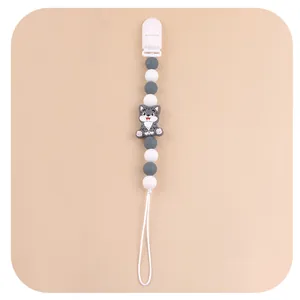 Detail view of cartoon cat pacifier clip with grey and white silicone beads on pink base