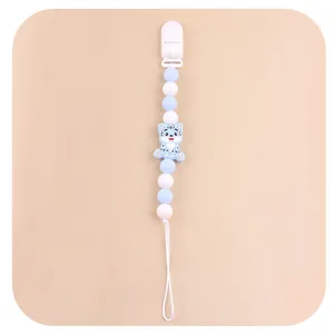 Detail of light blue baby pacifier clip with silicone beads and cartoon tiger charm