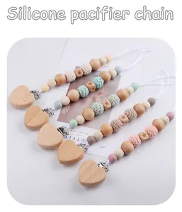 Detail of 5-pack DIY beech wood and silicone pacifier clips with heart-shaped clasps