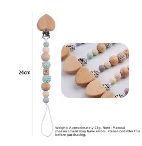 Detail view of 24cm beech wood heart pacifier clip with silicone beads and star engraving