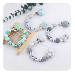 Silicone baby pacifier clips with bear charm and BABY letters in four pastel colors