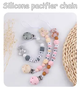 Detailed view of silicone pacifier chains with bear beads and customizable letter blocks