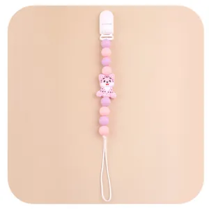 Close-up of pink tiger silicone beads and plastic clip on this baby pacifier chain