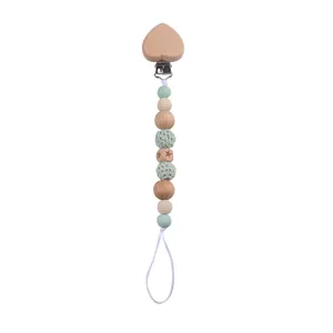Detail of wooden heart clip and silicone beads on a pacifier chain for babies
