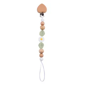 Detail of wooden heart clip and silicone daisy beads on baby pacifier chain