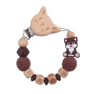 Dettaglio catenella portaciuccio in legno a forma di gatto con perline BABY