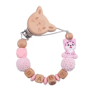 Dettaglio catenella portaciuccio in legno di faggio e silicone con gatto rosa
