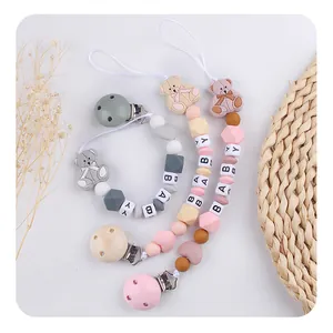 Baby pacifier clip with cartoon bear, silicone beads and letter beads on white background