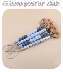 Detail of silicone pacifier clips with beech wood stars and baby letter beads