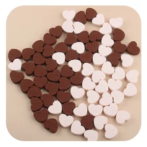 Macro view of heart-shaped silicone beads with floral embossing for DIY jewelry