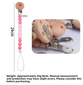Detail view of pink silicone pacifier clip with star wooden clasp and baby letter beads
