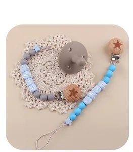 Detail of silicone pacifier set with beech wood clips and personalized letter beads