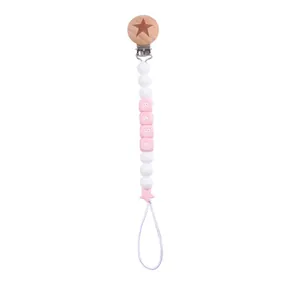 Detail of pink silicone beads and beech wood pacifier clip with star engraving