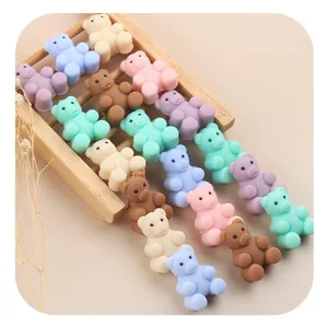Macro shot of colorful silicone bear beads on a mini wooden ladder for DIY pacifier chains