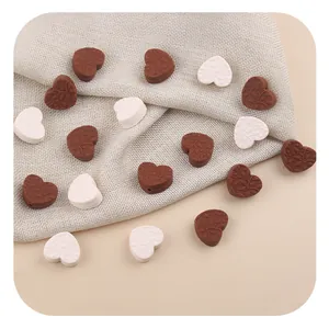 Detailed view of heart-shaped silicone beads with leaf relief for DIY craft necklaces