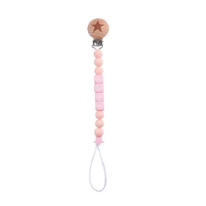 Detail of pink silicone beads and wooden clip on personalized baby pacifier chain