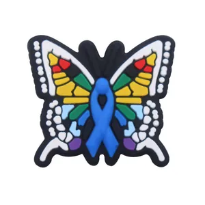 Close-up of a colorful butterfly PVC shoe charm featuring a blue ribbon motif