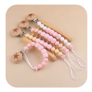 Pink and neutral silicone baby pacifier clips with beech wood stars and BABY letter beads