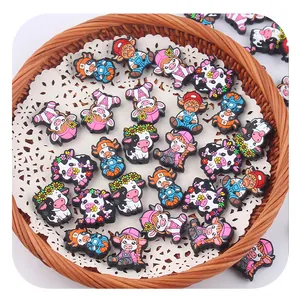 Macro detail of colorful cartoon cow PVC shoe charms for clogs and DIY accessories
