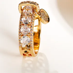 Gros plan d'une bague dorée avec motifs alvéolés et un pendentif en forme de disque