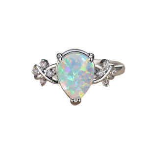 Elegant pear cut opal flower ring with white diamond accents in a silver setting