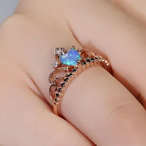 Elegant rose gold crown ring featuring a heart-shaped opal and white zircon accents
