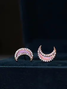 Macro detail of crescent moon earrings in rose gold with pink opal and pavé crystals