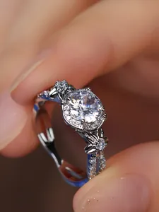 Macro detail of round diamond ring with flower side accents and halo setting