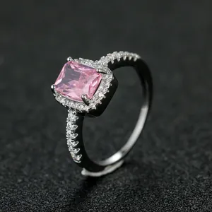 Macro detail of platinum plated halo ring featuring a rectangular pink cubic zirconia