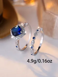 Close-up of square blue crystal wedding ring set in silver finish weighing 4.9g