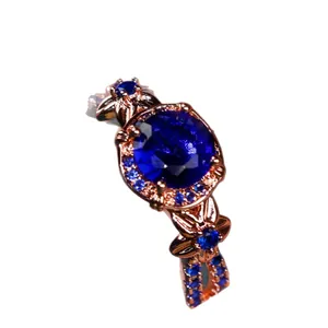 Elegant rose gold ring with large round blue gemstone and floral engraved band