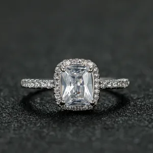 Macro shot of rectangular halo ring with radiant cut stone and pave diamond band