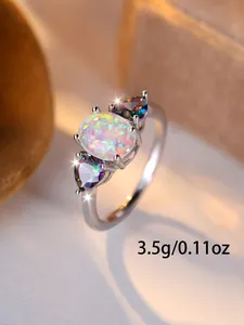 Detailed close-up of oval opal ring with side rainbow topaz stones weighing 3.5g