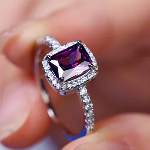 Elegant silver ring featuring rectangular purple gemstone and surrounding diamonds