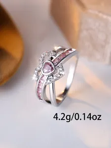 Detail of a silver ring with pink double heart stones and 4.2g weight specification