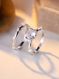 Macro shot of a silver ring set featuring a six-prong crown setting and pave stones
