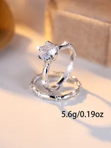 Macro shot of silver bridal ring set with sparkling diamonds and detailed engravings