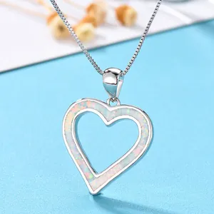 Elegant silver heart necklace featuring a white opal stone pendant on a box chain link