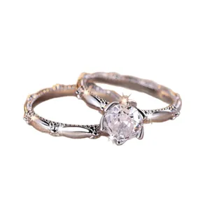 Elegant silver ring set featuring round brilliant cut solitaire and twisted band accents