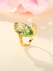 Detailed macro view of gold-tone dragonfly ring with olive green gemstone and 925 stamp