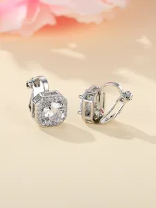 Close-up of silver halo clip-on earrings featuring round central zircon and small crystals