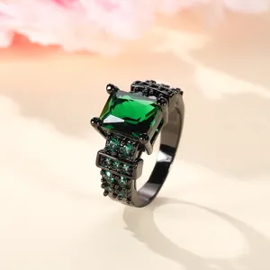 Macro view of vintage black plated ring with square green zircon and side pave stones