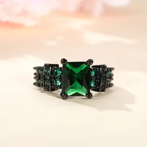 Elegant emerald cut green zircon ring with black plated metal and micro pave accents