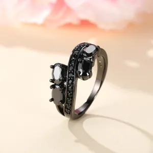 Macro detail of S925 engraved black ring with oval zircon stones and micro-pave crystals