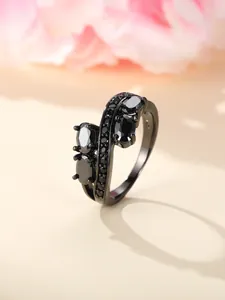 Close-up of black zircon pavé ring with S925 silver engraving and irregular oval stones