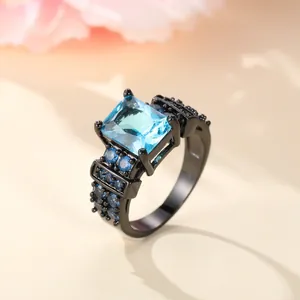 Elegant black plated ring featuring a square blue zircon center stone and side accents