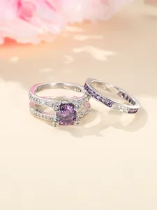 Detailopname van de tweeledige ringenset met paarse ronde stenen en zilveren band