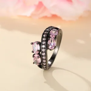 Detail of black alloy ring featuring pink oval zircons and pavé-set accent diamonds
