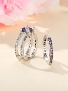 Macro detail van zilveren ringen met paarse ronde en vierkant geslepen kristallen en diamanten